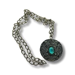 Large, pewter medallion pendant with blue glass.